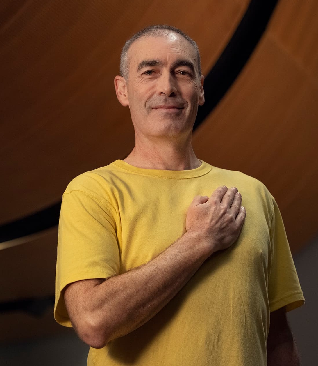 Greg Page, standing holding his heart on his heart