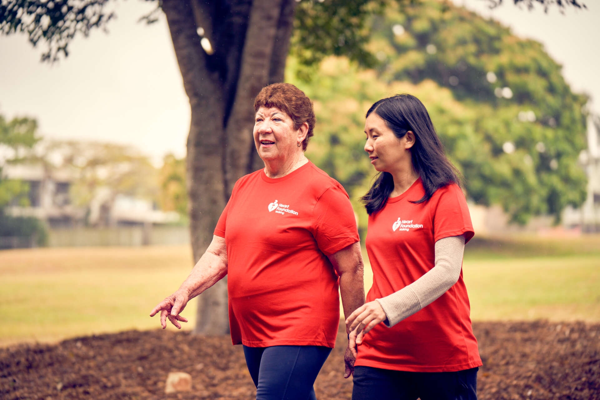 Two women walking with their Heart Foundation Walking t-shirts on