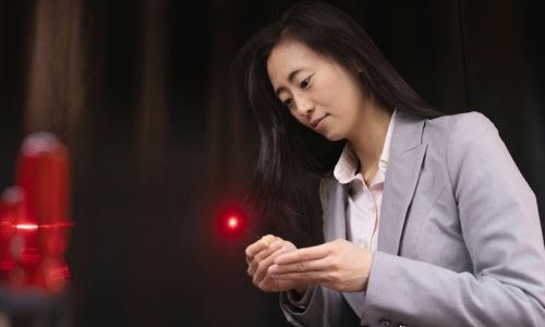 Jiawen Li in lab holding the catheter