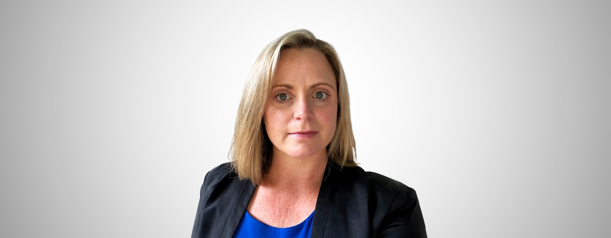 A woman with blonde hair wearing a black shirt.