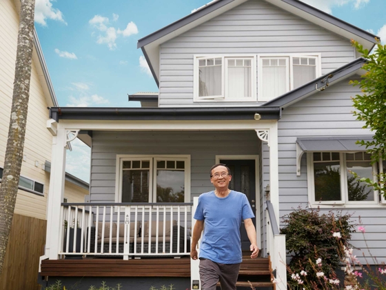Male walker in front of his house
