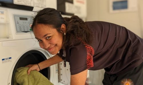 Photo of Remote Laundries worker putting washing in laundry machine